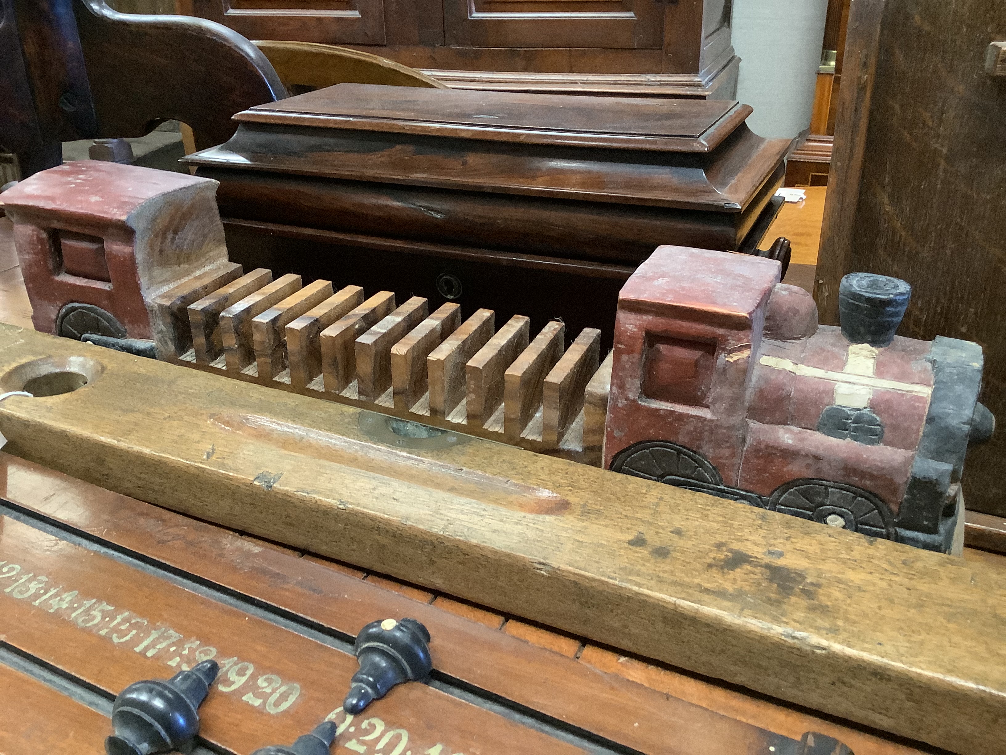 A Shove Ha'penny board, a Preston & Sons brass-mounted spirit level, a Riley's billiards scoreboard and a tea caddy